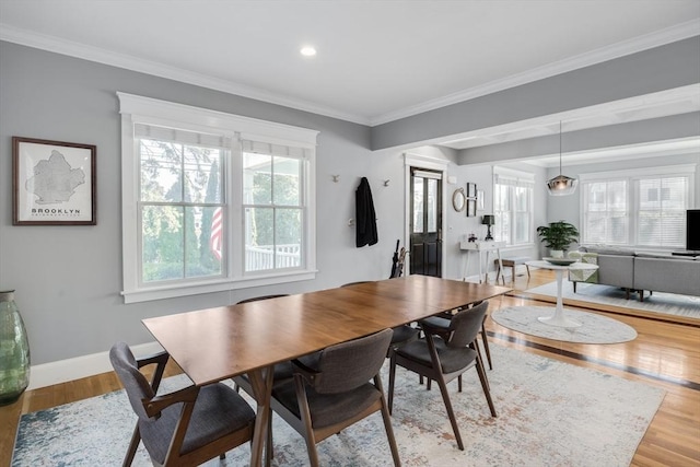 dining area with baseboards, recessed lighting, crown molding, and wood finished floors