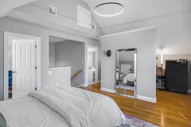 bedroom featuring baseboards, high vaulted ceiling, visible vents, and wood finished floors