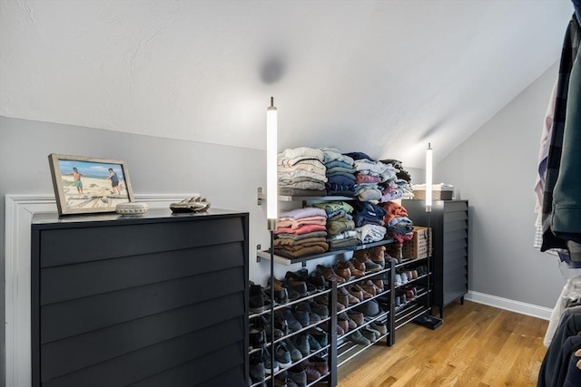 spacious closet with vaulted ceiling and wood finished floors
