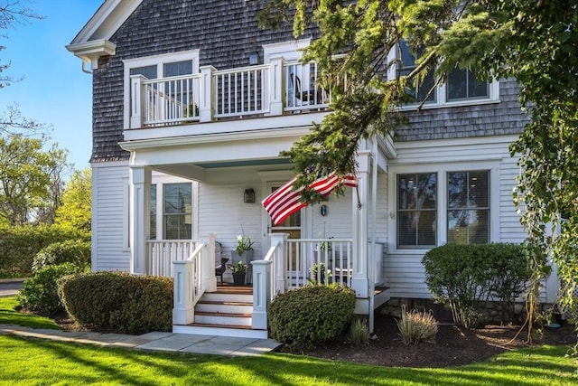 exterior space featuring a porch and a balcony