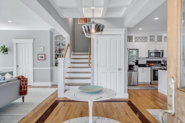 entryway featuring crown molding, stairway, light wood-style flooring, and recessed lighting