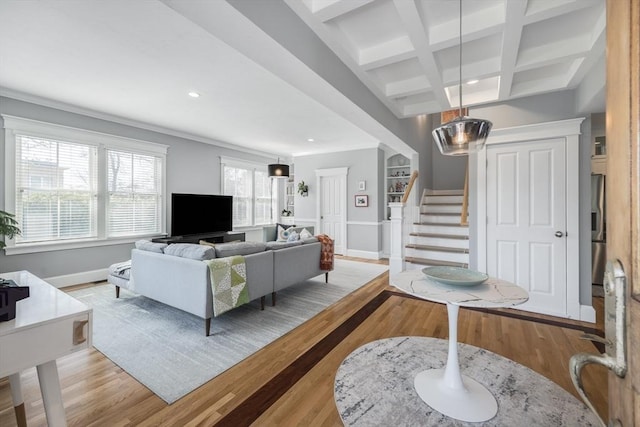 living room featuring recessed lighting, baseboards, light wood-style floors, beamed ceiling, and stairway