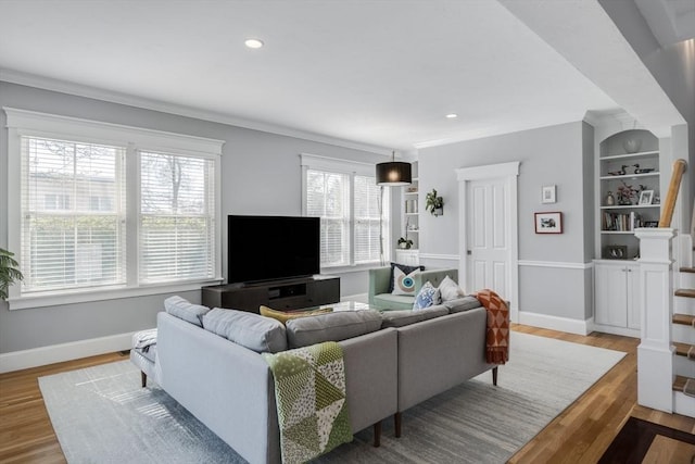 living area featuring baseboards, ornamental molding, recessed lighting, and wood finished floors