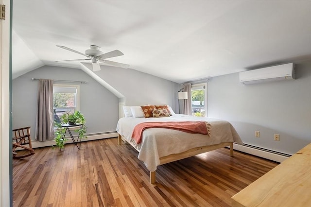 bedroom featuring a wall mounted air conditioner, multiple windows, a baseboard heating unit, and hardwood / wood-style flooring