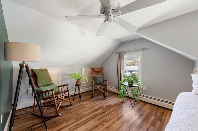 sitting room featuring a ceiling fan, baseboards, wood finished floors, a baseboard radiator, and vaulted ceiling