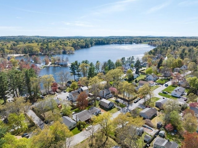bird's eye view featuring a residential view, a water view, and a wooded view