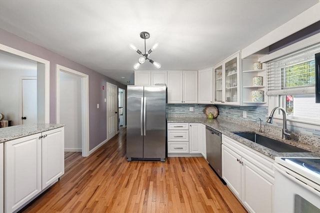 kitchen featuring open shelves, a sink, white cabinets, a chandelier, and stainless steel appliances