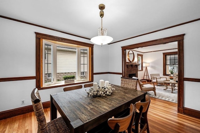 33 Intervale Ave, Saugus, MA 01906 - dining area featuring healthy amount of natural light, wood finished floors, ornamental molding, and a fireplace