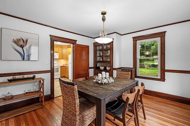33 Intervale Ave, Saugus, MA 01906 - dining room with light wood-type flooring and ornamental molding