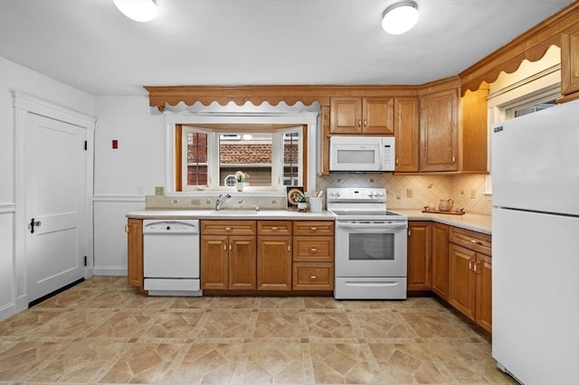 33 Intervale Ave, Saugus, MA 01906 - kitchen featuring white appliances, light countertops, brown cabinets, and decorative backsplash