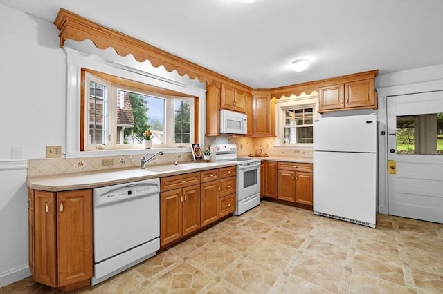 33 Intervale Ave, Saugus, MA 01906 - kitchen with white appliances, decorative backsplash, and brown cabinets