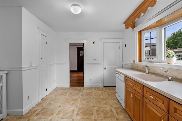 33 Intervale Ave, Saugus, MA 01906 - kitchen with white dishwasher, light countertops, decorative backsplash, and brown cabinetry