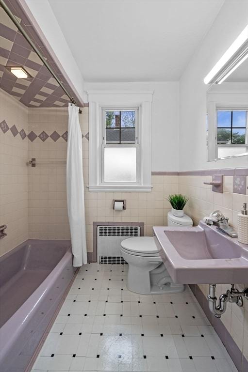 33 Intervale Ave, Saugus, MA 01906 - bathroom featuring radiator heating unit, tile walls, plenty of natural light, shower / tub combo, and wainscoting