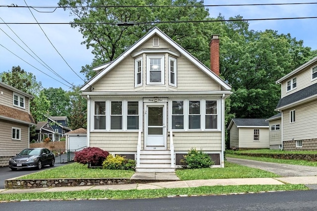 33 Intervale Ave, Saugus, MA 01906 - bungalow-style home with entry steps, a chimney, and a front yard