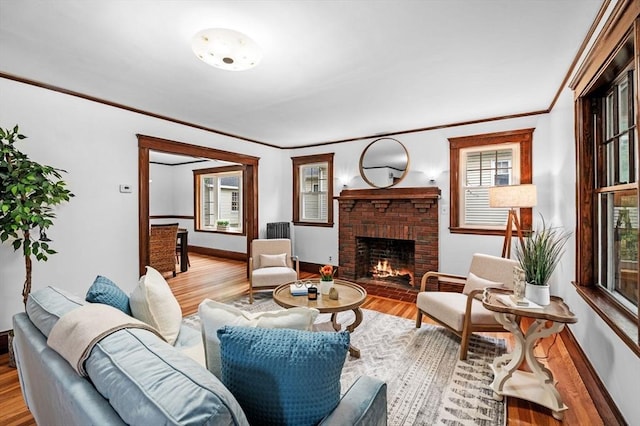33 Intervale Ave, Saugus, MA 01906 - living area with a brick fireplace, wood finished floors, and ornamental molding
