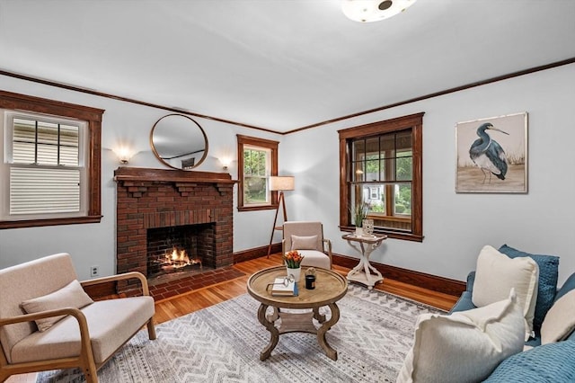33 Intervale Ave, Saugus, MA 01906 - living area featuring a brick fireplace, ornamental molding, wood finished floors, and healthy amount of natural light