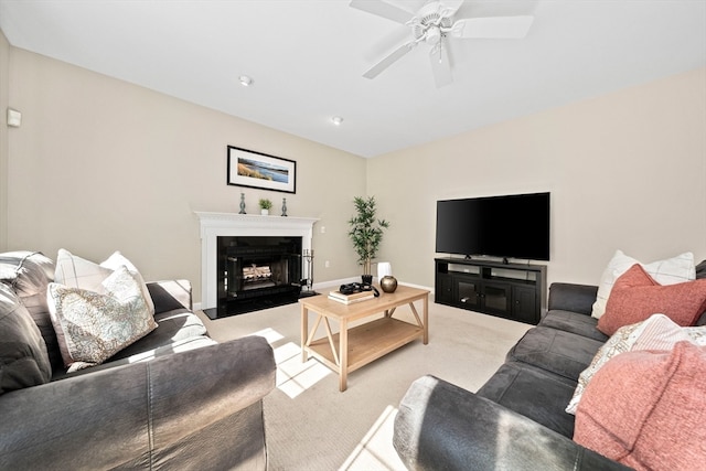 carpeted living room with ceiling fan