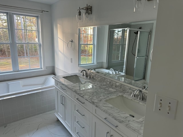 bathroom with vanity and shower with separate bathtub