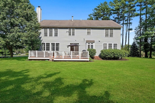 back of house with a yard and a deck