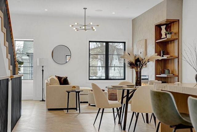 dining space featuring a wealth of natural light, a notable chandelier, light wood finished floors, and recessed lighting