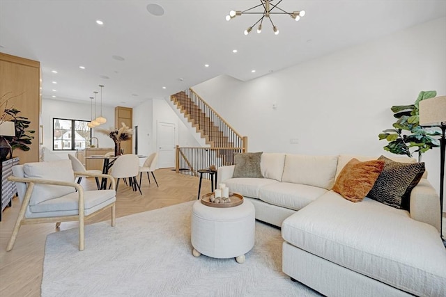 living room with stairs, a notable chandelier, and recessed lighting