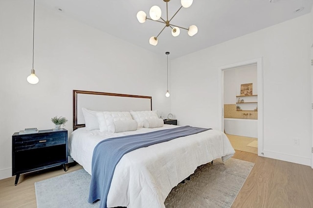 bedroom with light wood-style flooring, baseboards, and an inviting chandelier