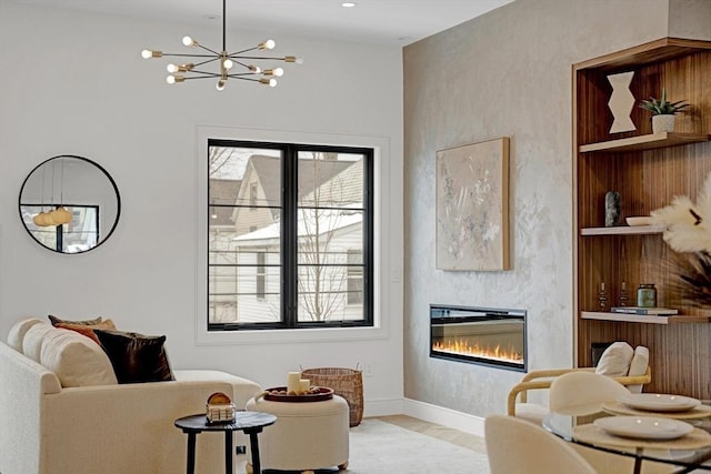 living area with built in features, a glass covered fireplace, plenty of natural light, and wood finished floors