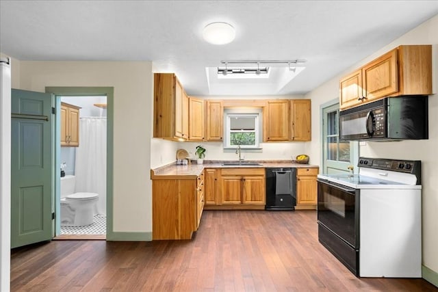 39 Mashapaug Rd, Sturbridge, MA 01566 - kitchen with black appliances, light countertops, track lighting, and dark wood-style floors
