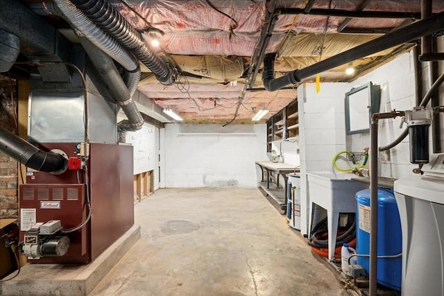 39 Mashapaug Rd, Sturbridge, MA 01566 - unfinished basement featuring a water pressure tank, heating unit, and concrete block wall
