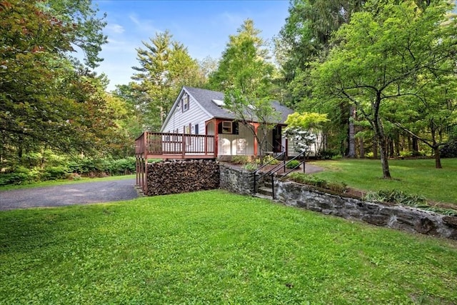 39 Mashapaug Rd, Sturbridge, MA 01566 - view of front of house featuring a wooden deck, a front yard, and asphalt driveway