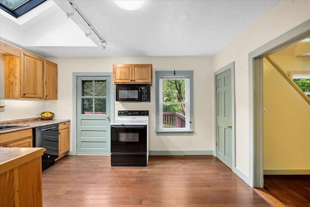 39 Mashapaug Rd, Sturbridge, MA 01566 - kitchen featuring black appliances, hardwood / wood-style floors, healthy amount of natural light, and a skylight