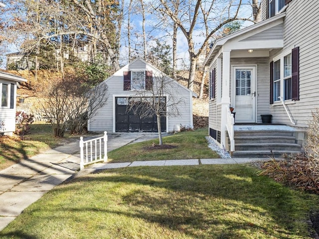 exterior space featuring a garage, an outbuilding, and driveway