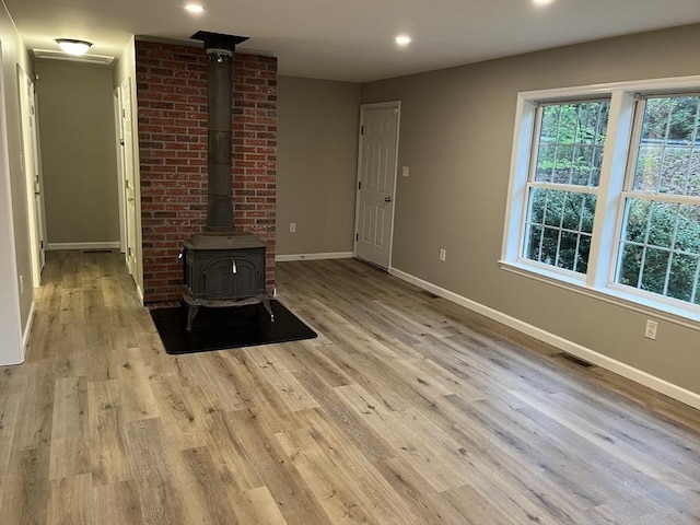 48 N Main St, New Salem, MA 01355 - unfurnished living room with a wood stove, baseboards, light wood-style floors, and recessed lighting