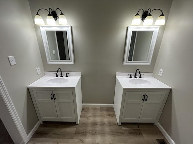 48 N Main St, New Salem, MA 01355 - bathroom with two vanities, wood finished floors, and baseboards