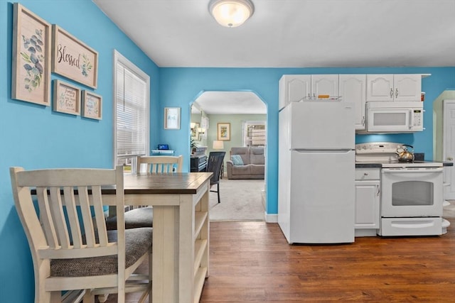 48 Gorham Ave, Stoneham, MA 02180 - kitchen with white appliances, arched walkways, healthy amount of natural light, and white cabinets