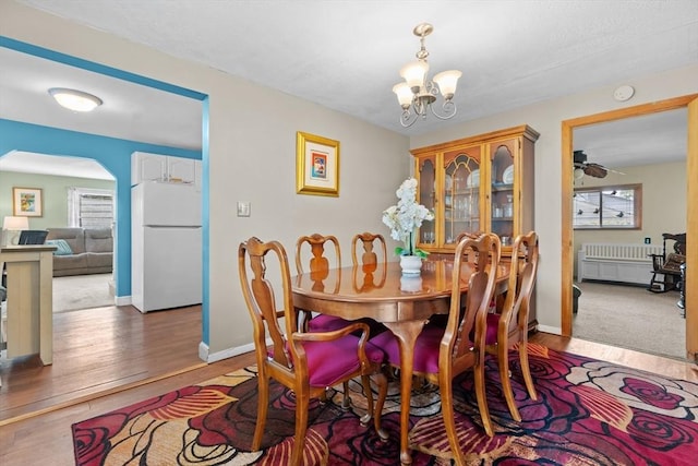 48 Gorham Ave, Stoneham, MA 02180 - dining space with healthy amount of natural light, arched walkways, wood finished floors, and a chandelier