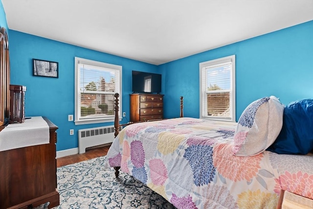 48 Gorham Ave, Stoneham, MA 02180 - bedroom featuring radiator, multiple windows, wood finished floors, and baseboards