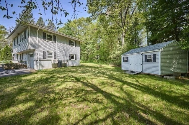 view of grassy yard with a shed and an outdoor structure