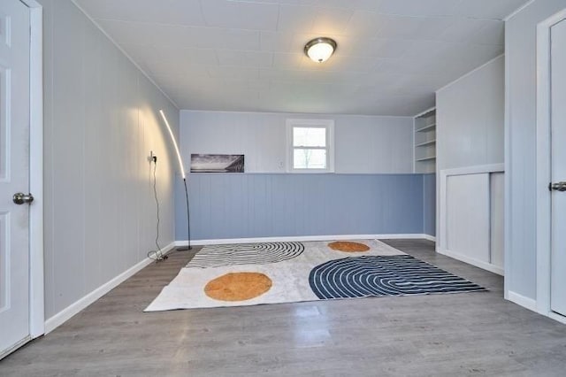 empty room with wood finished floors and baseboards