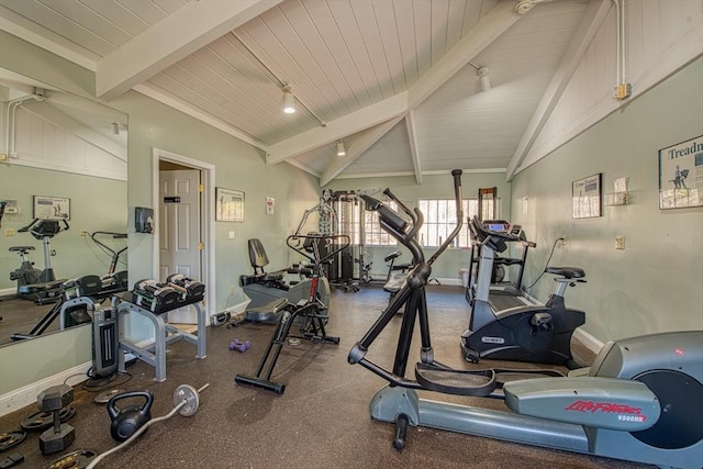 exercise room with lofted ceiling, wood ceiling, and baseboards