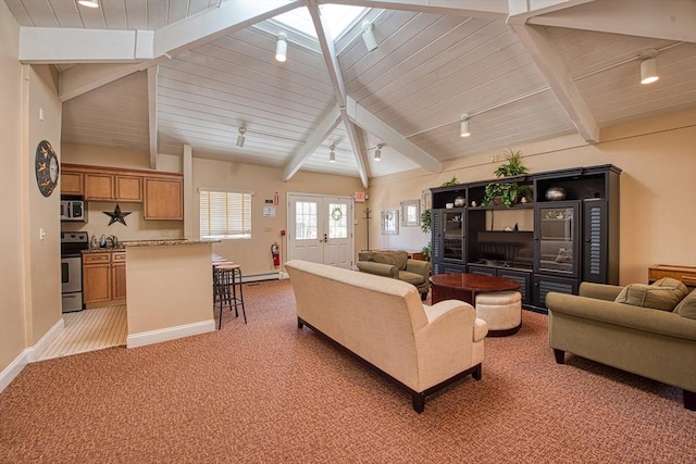 living area with rail lighting, wood ceiling, baseboards, and light carpet