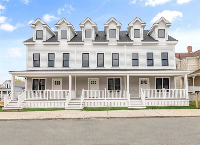 view of front of property featuring a shingled roof and a porch