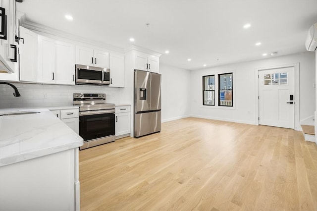kitchen with a sink, appliances with stainless steel finishes, decorative backsplash, and recessed lighting