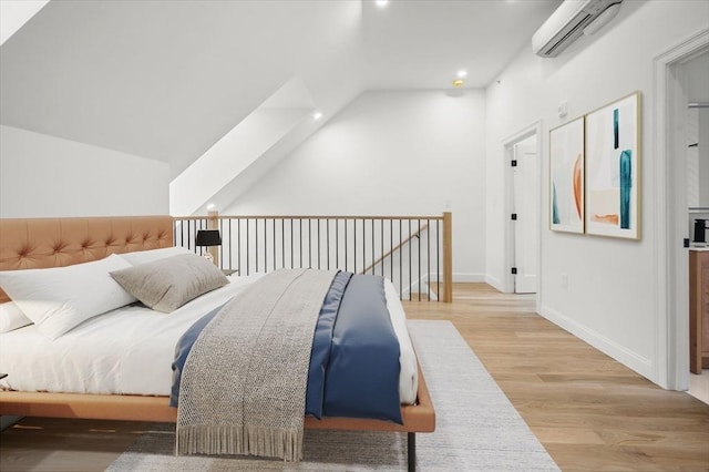 bedroom featuring wood finished floors, baseboards, a wall mounted air conditioner, recessed lighting, and vaulted ceiling