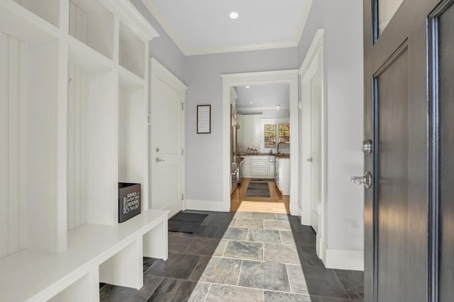 mudroom featuring recessed lighting, stone tile floors, and baseboards