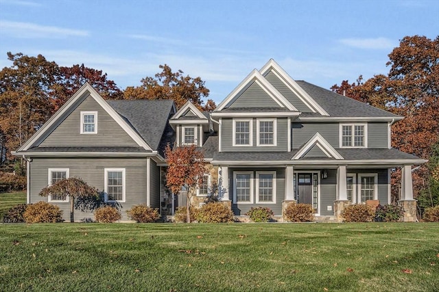 view of front of house with covered porch and a front yard