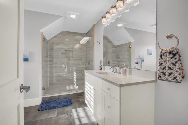 bathroom with a shower stall, vanity, and baseboards