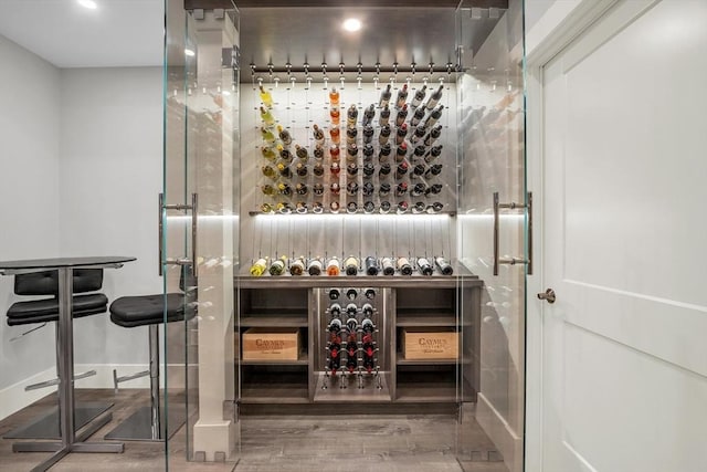 wine cellar with baseboards and wood finished floors