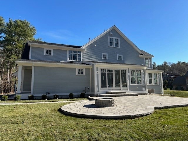 back of property featuring a patio, an outdoor fire pit, and a lawn