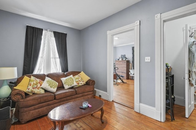 living area with baseboards and light wood-style floors